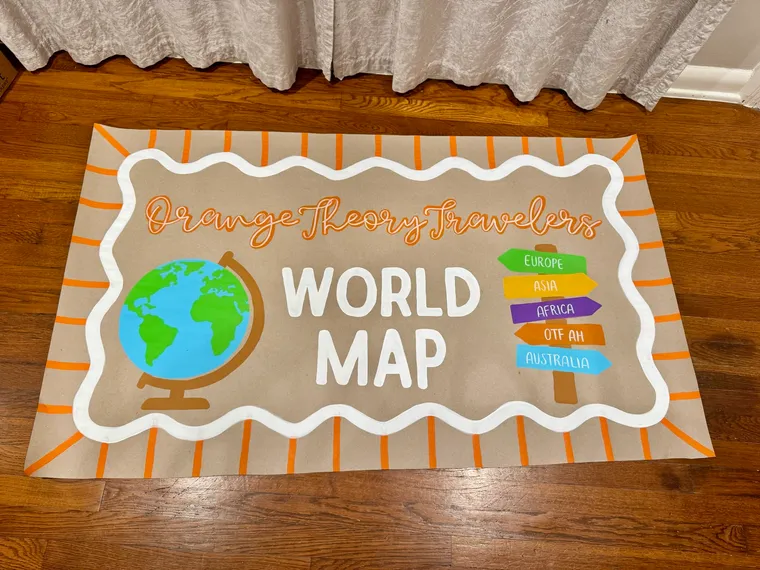 Hand-painted corporate banner being painted on kraft paper for a business event with brand colors